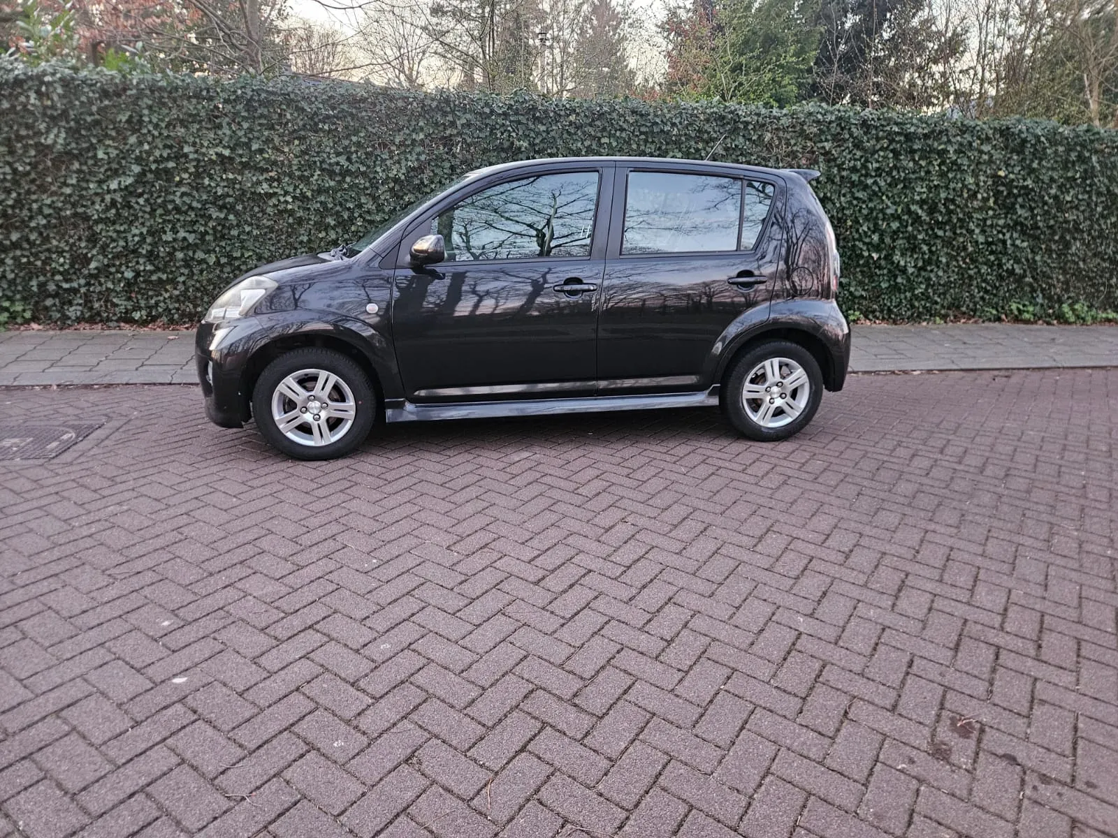 Zwarte Daihatsu Sirion Sport, zijaanzicht